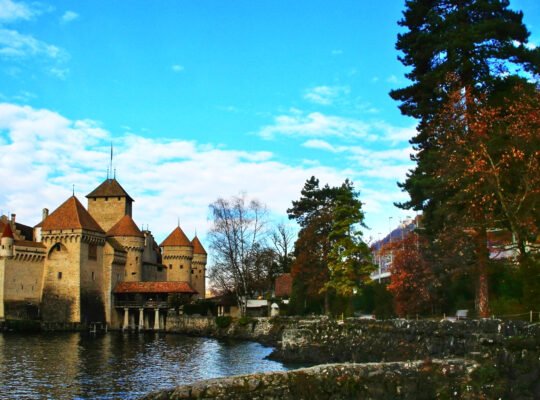 Chillon Castle by tranquil lake with towers