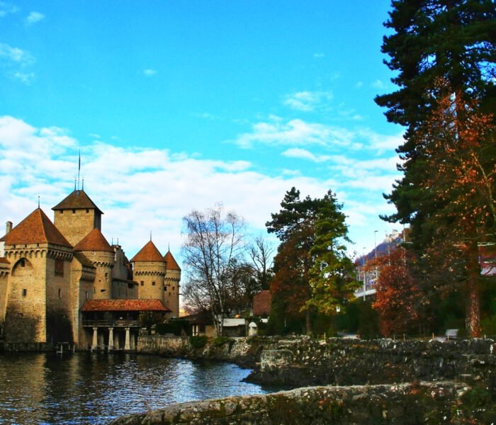 Chillon Castle by tranquil lake with towers