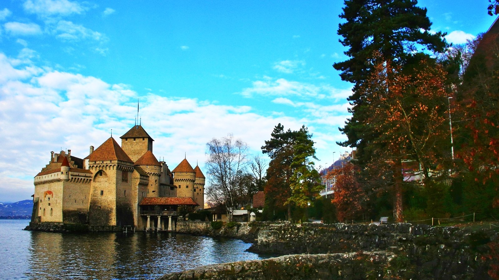 Chillon Castle by tranquil lake with towers
