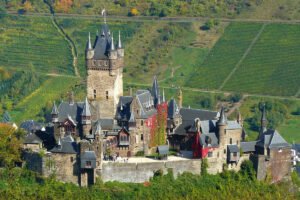 Cochem Castle on hill with vineyards and river view