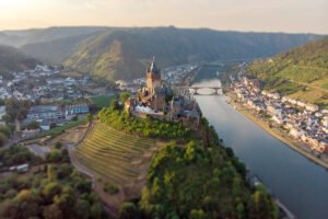 Aerial view of Cochem Castle perched above the Moselle River and vineyards