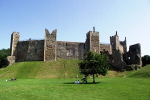 Framlingham Castle ruins above green grassy mound