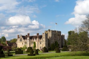 Hever Castle historic manor and manicured gardens under blue sky