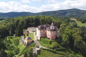 Aerial view of Jansky Vrch Castle perched above wooded valley
