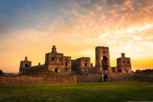 Ruined Krzyztopor Castle silhouetted at sunset