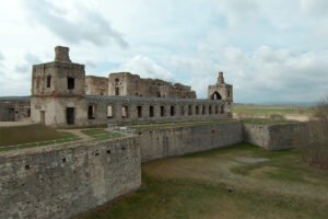 Krzyztopor Castle ruins and defensive walls under cloudy sky