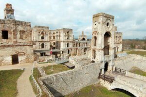 Krzyztopor Castle ruins courtyard and tower under cloudy sky