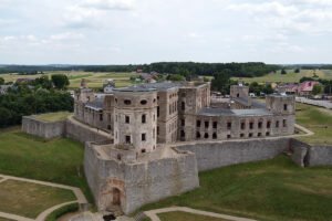 Aerial view of Krzyztopor Castle ruins on grassy plateau