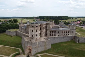 Aerial view of Krzyztopor Castle ruins on grassy plateau