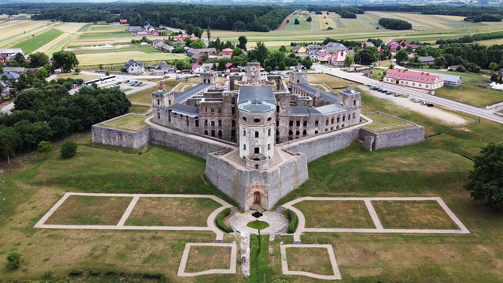 Aerial view of Krzyztopor Castle ruins surrounded by fields