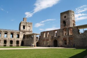 Courtyard ruins of Krzyztopor Castle under blue summer sky