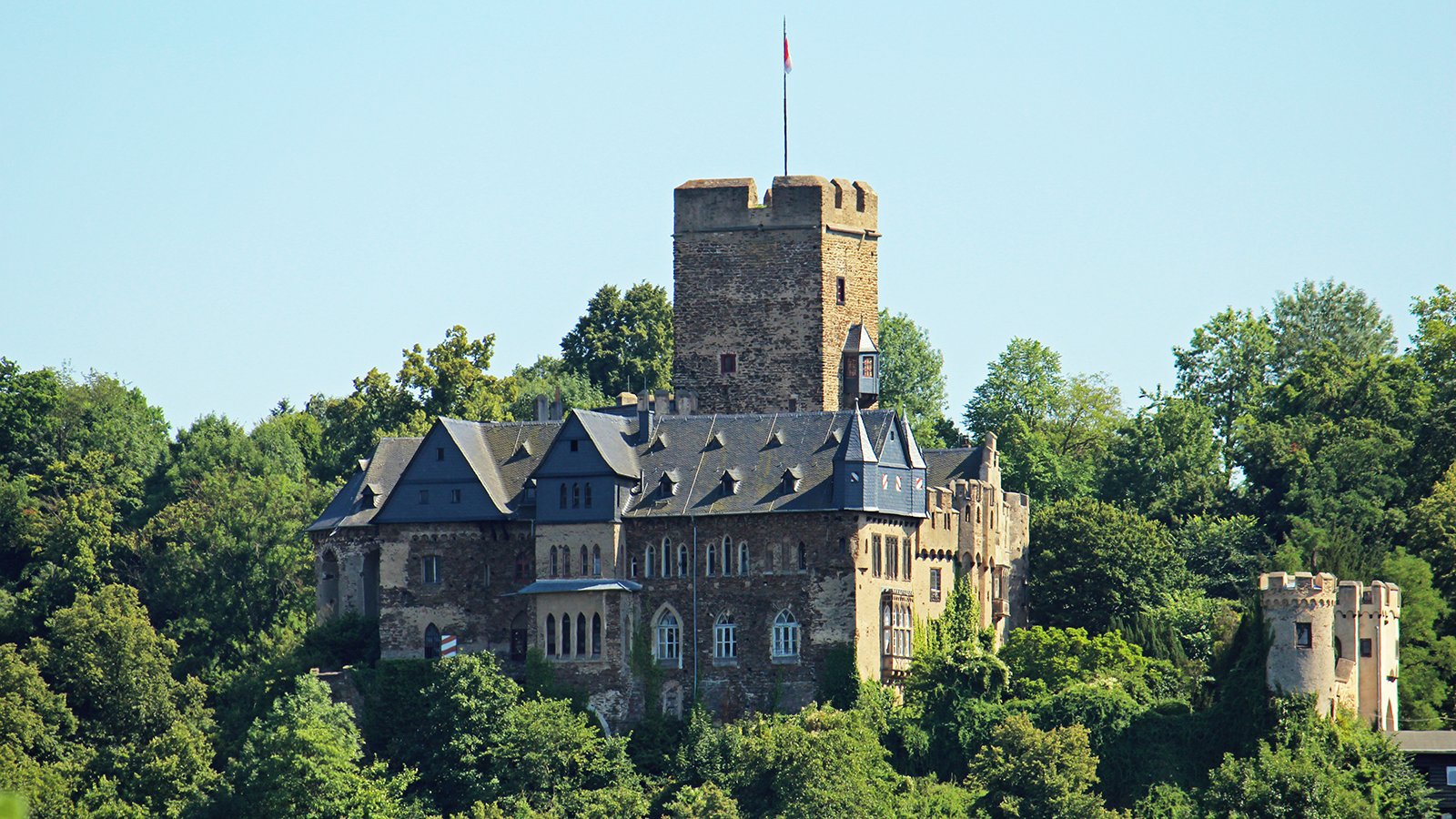 Lahneck Castle hilltop tower surrounded by trees