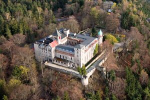 Aerial view of Lesna Skala Castle on forested hilltop