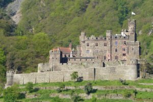 Reichenstein Castle perched on green hillside above the Rhine