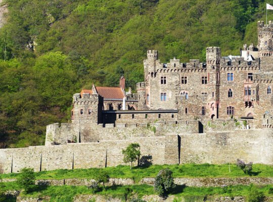 Reichenstein Castle perched on forested hillside overlooking valley