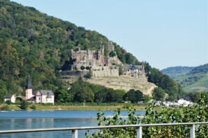 Reichenstein Castle atop wooded Rhine hill by the river