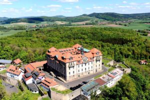 Aerial view of Bieberstein Palace, Hesse surrounded by forests and fields