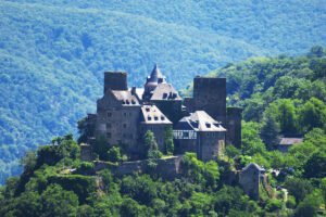 Schönburg Castle perched on green hilltop with forested valley
