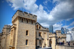 Stone battlements of The Tower of London under a blue sky