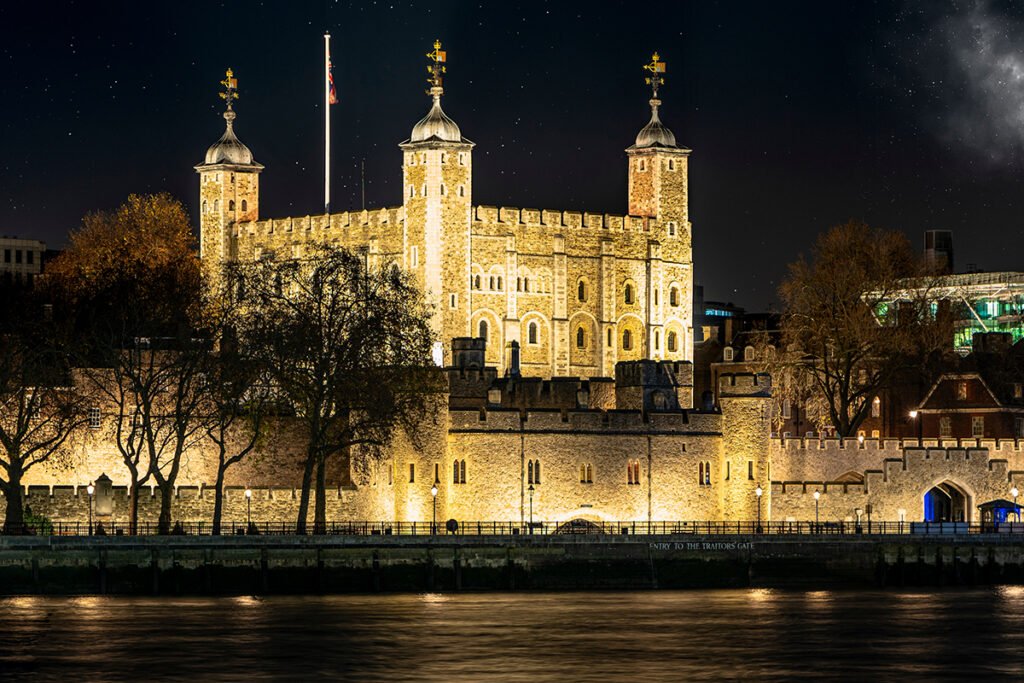 The Tower of London illuminated along River Thames at night