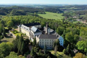 Aerial view of Zbiroh Castle and surrounding forested hills