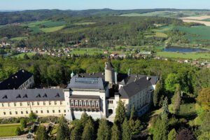 Aerial view of Zbiroh Castle with surrounding forests and ponds