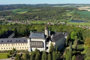 Aerial view of Zbiroh Castle with surrounding forests and ponds