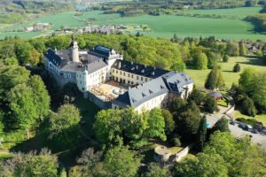 Aerial view of Zbiroh Castle on wooded hilltop