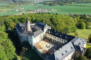 Aerial view of Zbiroh Castle courtyard and surrounding forested landscape