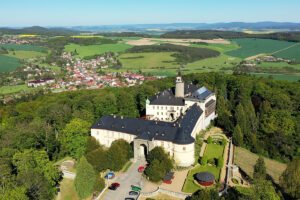 Aerial view of Zbiroh Castle on wooded hilltop