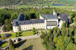Aerial view of Zbiroh Castle with terraced gardens and surrounding forest