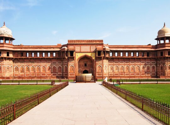 Front view of Agra Fort red sandstone façade, pathway and lawns