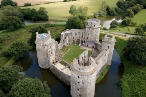 Aerial view of Hunaudaye Castle surrounded by moat and green fields