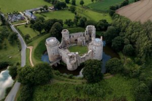 Aerial view of Hunaudaye Castle surrounded by moat and woodland