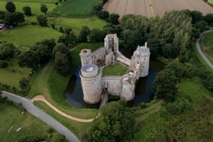 Aerial view of Hunaudaye Castle surrounded by moat and fields