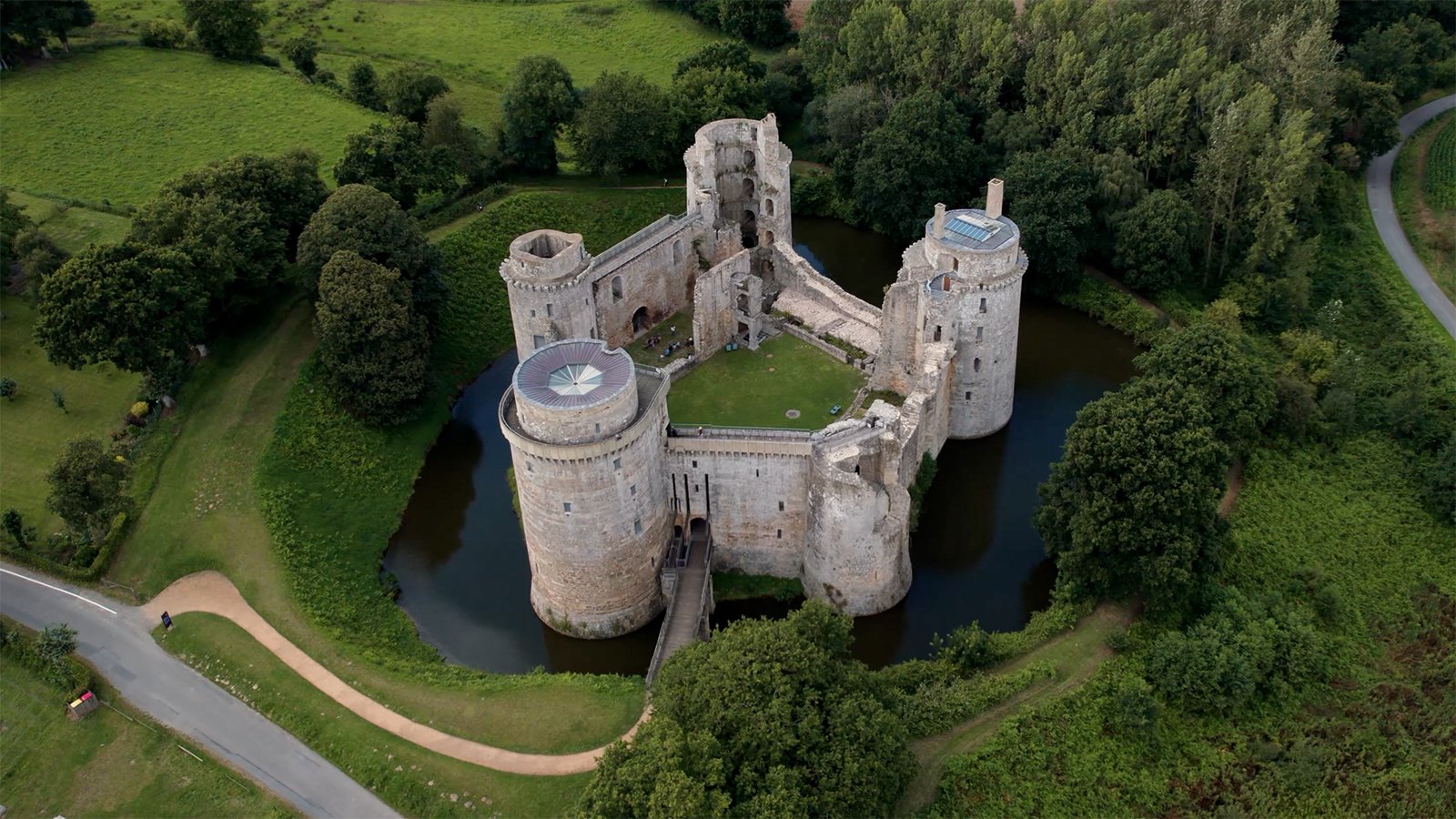 Aerial view of Hunaudaye Castle surrounded by moat and trees