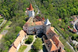 Aerial view of Krivoklat Castle perched above forested valley