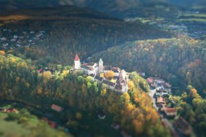 Aerial view of Krivoklat Castle surrounded by autumn woodland