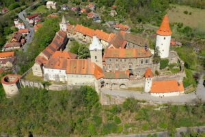 Aerial view of Krivoklat Castle perched on wooded hill