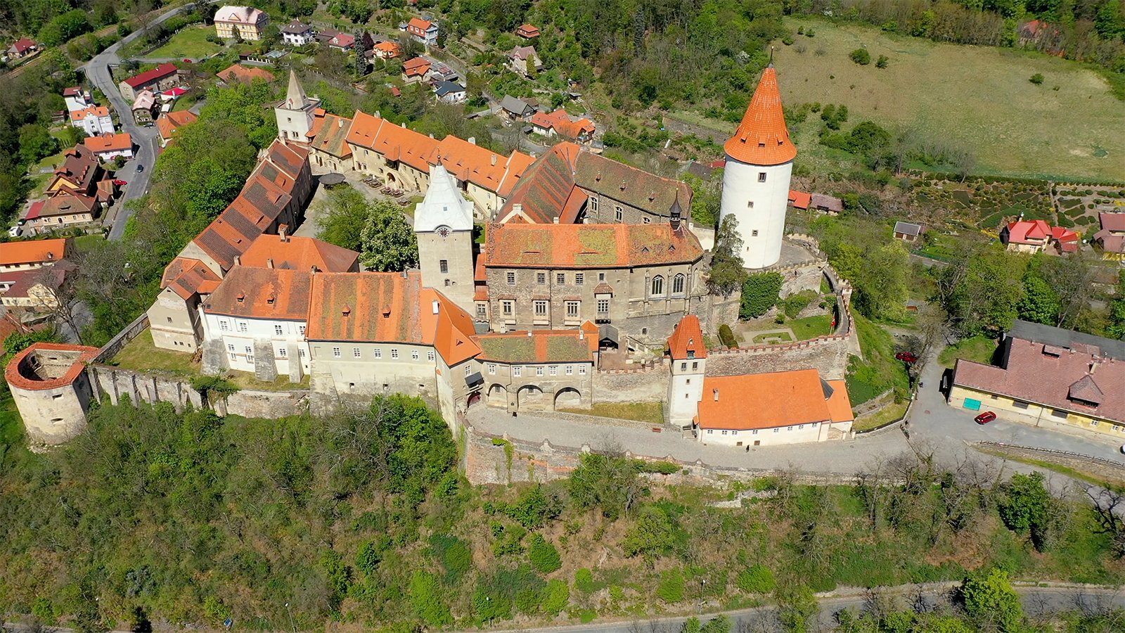 Aerial view of Krivoklat Castle perched above wooded valley