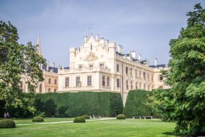 Lednice Castle facade and formal gardens under blue sky