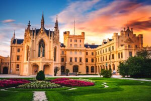 Lednice Castle façade with gardens at golden sunset