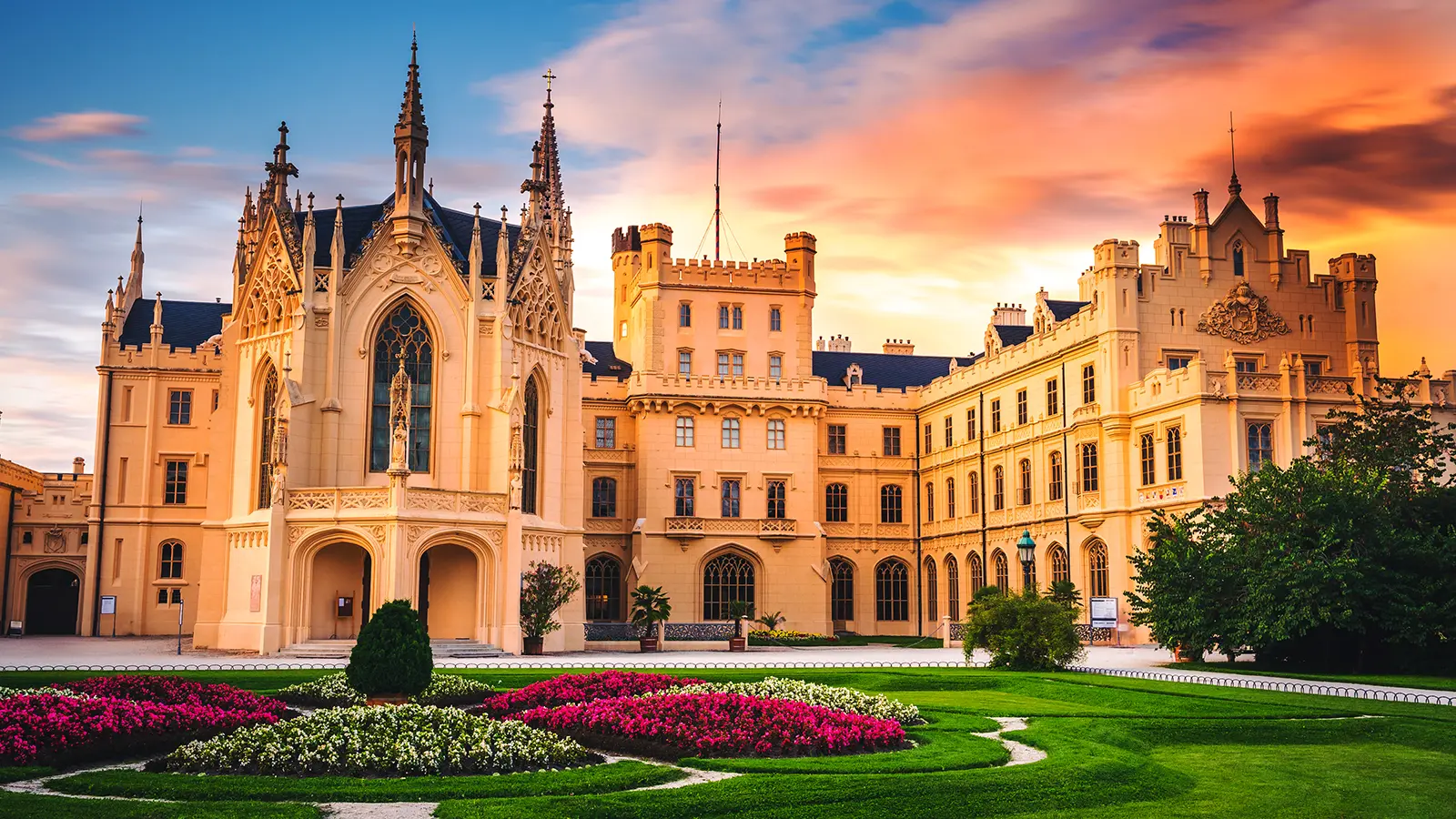 Lednice Castle facade with gardens at sunset