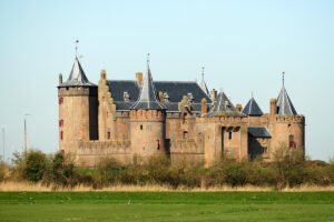 Muiderslot Castle beside green meadow and moat