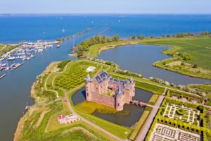 Aerial view of Muiderslot Castle with moat, gardens and IJmeer coast