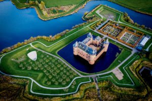 Aerial view of Muiderslot Castle surrounded by moat and gardens