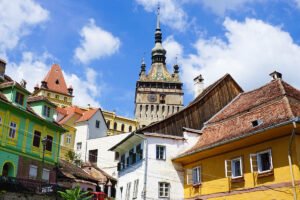Sighișoara Citadel clock tower above colorful houses