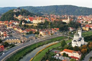Aerial view of Sighișoara Citadel on hill with river and cathedral