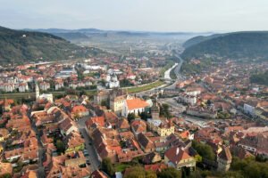 Aerial view of Sighișoara Citadel and red-roofed medieval town