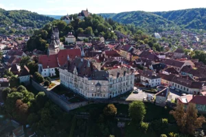 Aerial view of Sighișoara Citadel atop wooded hill